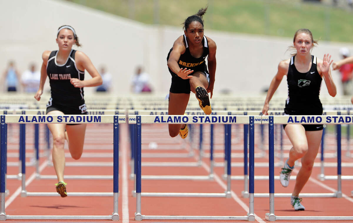 Brennan's Autym Scales (center) clears the final hurdle on her way to winning the 4A girls 100 meter hurdles during the Region IV Track Meet on April 28, 2012 at Alamo Stadium in San Antonio Texas. John Albright / Special to the Express-News.