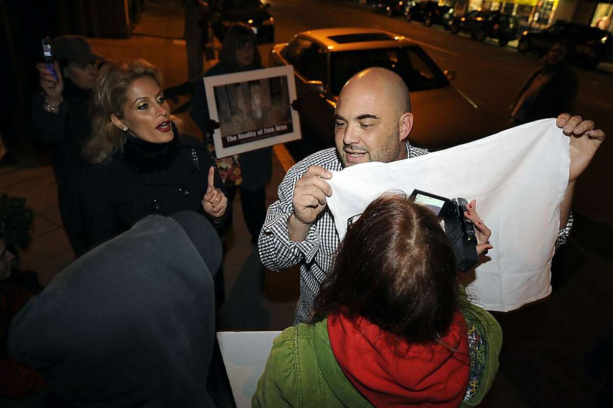 An unamed patron gets into a heated exchange with protestors outside the restaurant who he said are disturbing his dinner. Protesters gathered in front of Baywolf restaurant in Oakland, CA to protest their special "Farewell to Foie Gras" dinner Sunday Feb. 26th, 2012
