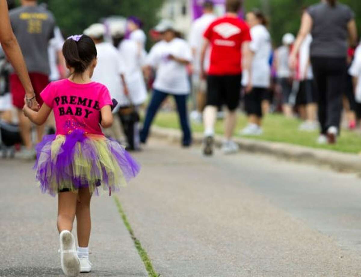 Athena Garcia joins the thousands of walkers during the Houston March for Babies Sunday, April 29, 2012, in Houston. Thousands of walkers took to the streets around the University of Houston campus to raise money for the March of Dimes, supporting lifesaving research and community programs that help mothers have healthy, full-term pregnancies and strong, healthy babies. ( Brett Coomer / Houston Chronicle ) (Brett Coomer / Houston Chronicle)