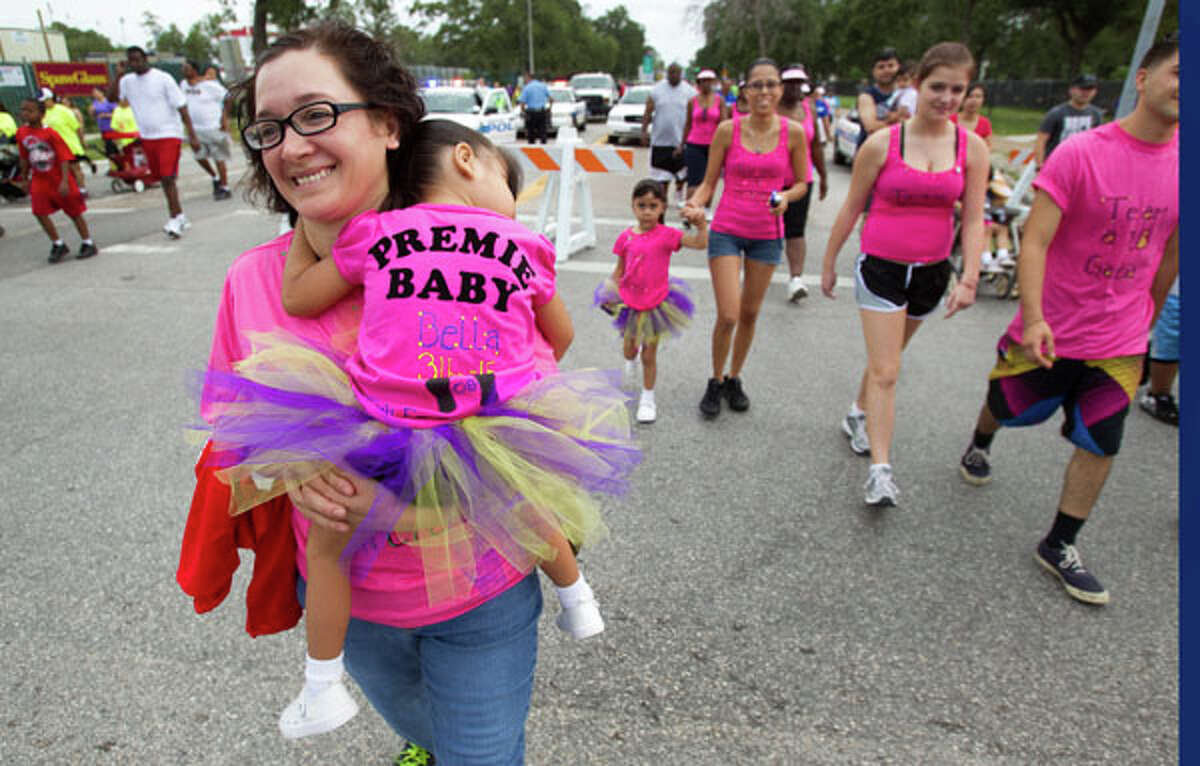 Gemma Garcia, carries her granddaughter, Bella Garcia during the Houston March for Babies Sunday, April 29, 2012, in Houston. Thousands of walkers took to the streets around the University of Houston campus to raise money for the March of Dimes, supporting lifesaving research and community programs that help mothers have healthy, full-term pregnancies and strong, healthy babies. ( Brett Coomer / Houston Chronicle )