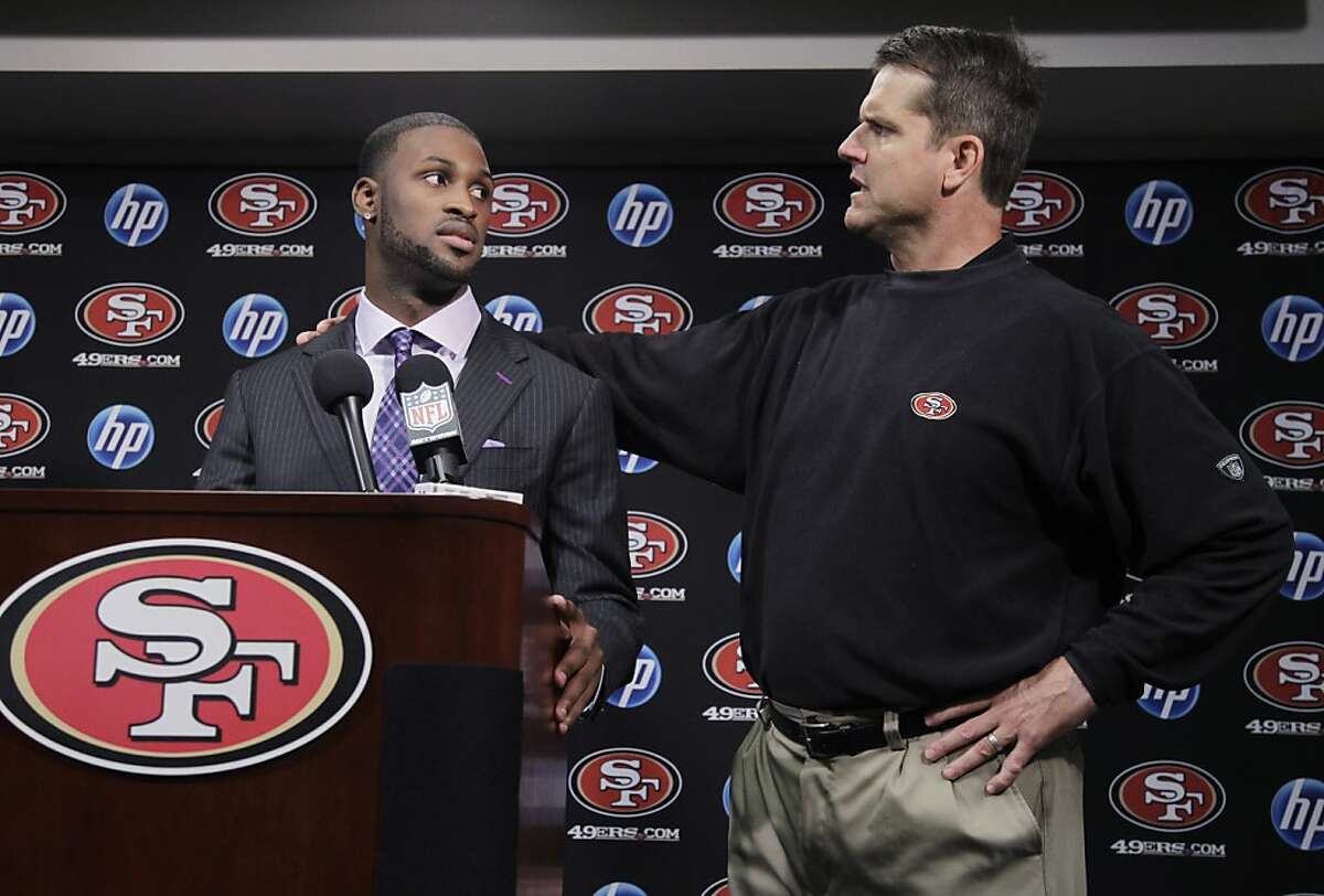 San Francisco 49ers first round draft pick A.J. Jenkins, left, a wide receiver from Illinois, and head coach Jim Harbaugh, right, look at each other during an NFL football news conference at the team's headquarters in Santa Clara, Calif., Friday, April 27, 2012. (AP Photo/Paul Sakuma)