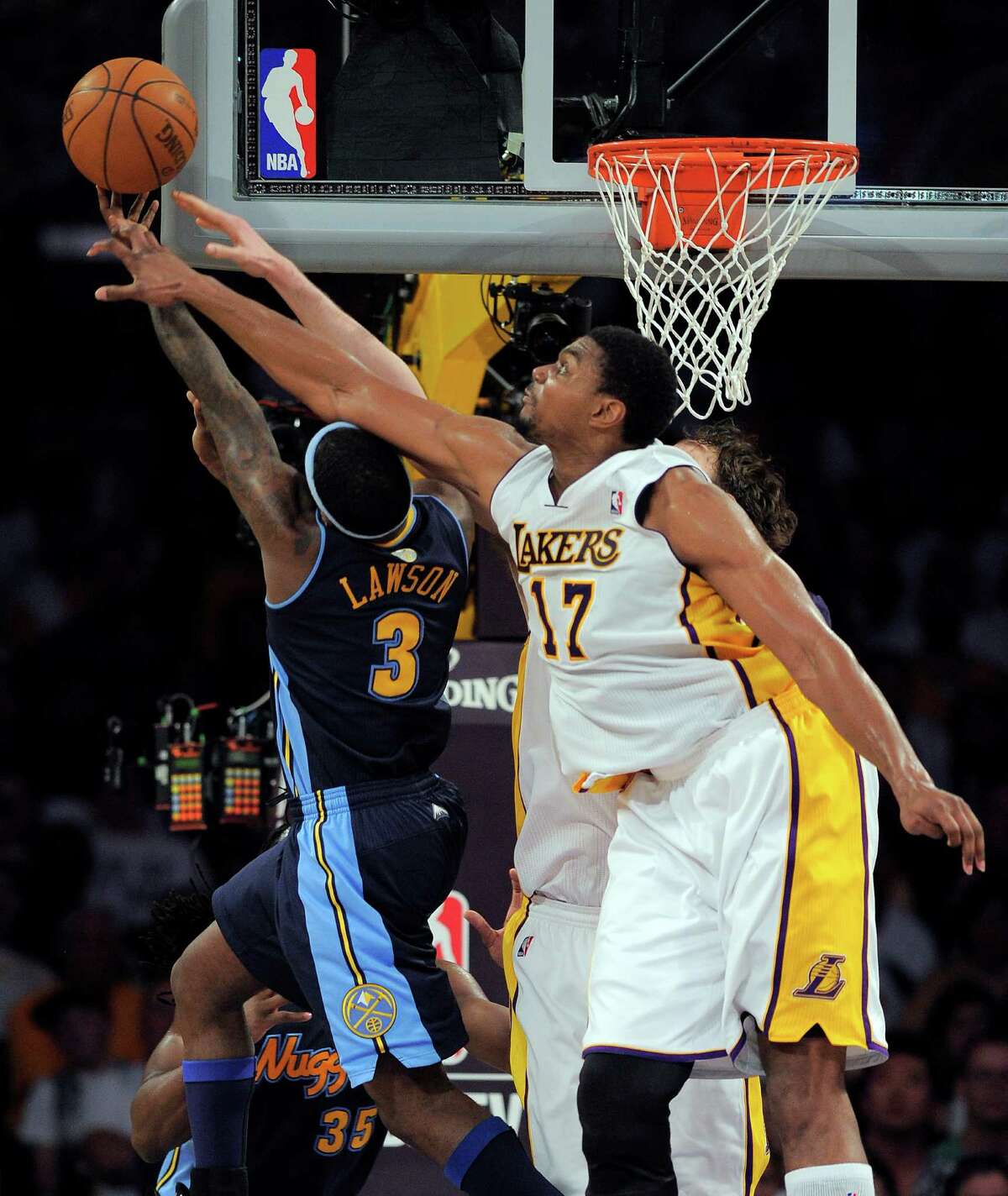 Los Angeles Lakers' Caron Butler, right, fouls Houston Rockets