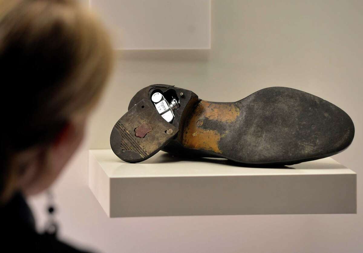 A visitor looks at a shoe which belonged to a Russian spy with a mini camera inside the heel at the spy museum in Oberhausen, Germany, in 2012.