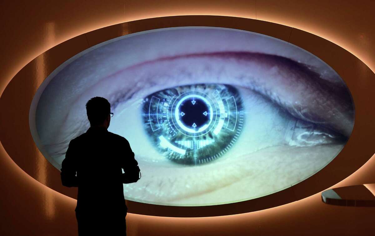 A man watches a screen that shows an eye being scanned at the new spy museum in Oberhausen, Germany, Monday, April 30, 2012. The exhibition "Top Secret" explains the work of secret services and shows unique original details from the Russian KGB, the CIA and the east German STASI during the cold war. (AP Photo/Martin Meissner)