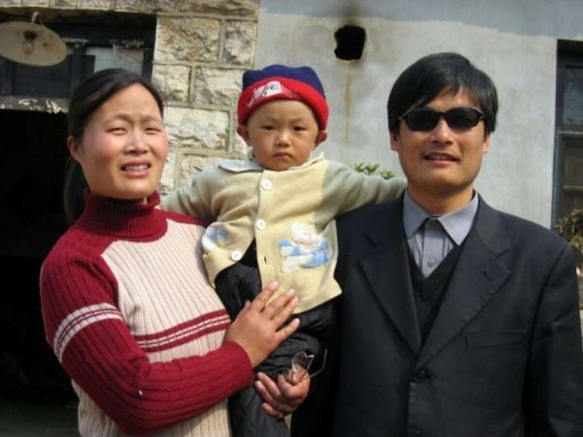 This undated photo provided by the China Aid Association shows blind Chinese legal activist Chen Guangchen, right, with his son, Chen Kerui, with his wife Yuan Weijing, left, in Shandong province, China. Chen, a well-known dissident who angered authorities in rural China by exposing forced abortions, made a surprise escape from house arrest on April 22, 2012, into what activists say is the protection of U.S. diplomats in Beijing, posing a delicate diplomatic crisis for both governments.