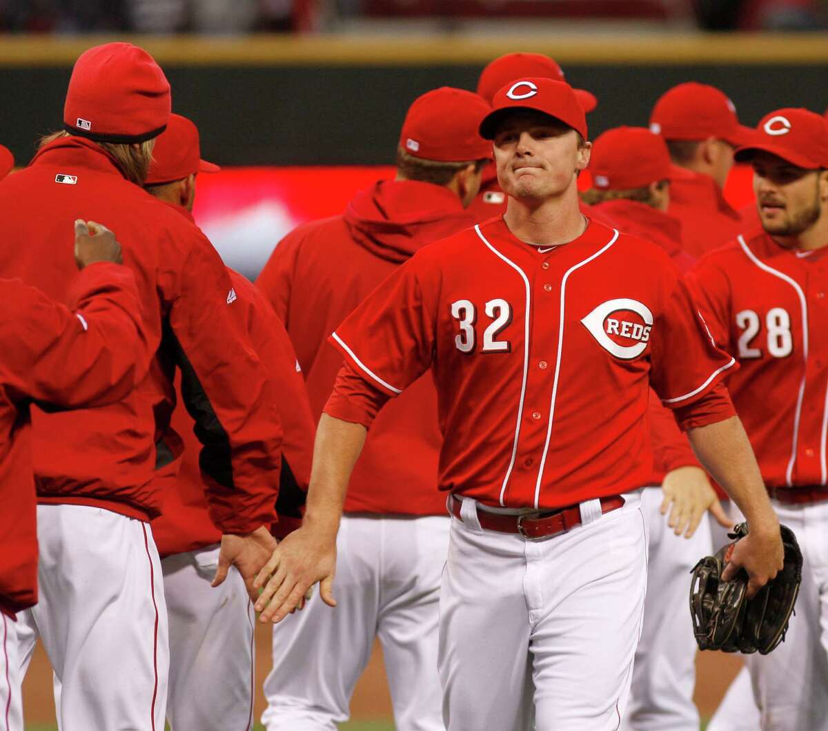 Cincinnati Reds' Jay Bruce (32) is congratulated by teammates after they defeated the Houston Astros 6-0 during a baseball game on Saturday, April 28, 2012, in Cincinnati. The Reds won 6-0. (AP Photo/David Kohl)