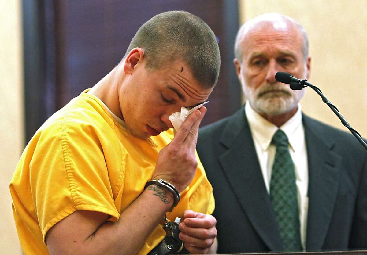 Ryan Dougherty wipes tears from his eyes in district court in Walsenburg, Colo., on Monday, April 30, 2012, where he was sentenced to 18 years in prison on charges stemming from he and his siblings shootout and capture in Colorado. Attorney Michael Emmons looks on at right. All three siblings were sentenced on Monday. The three are accused of shooting at a police officer and staging a daring bank robbery in a cross-country crime spree that included Georgia and Florida. The manhunt for them ended after an Aug. 10 freeway chase and shootout with police in southern Colorado. (AP Photo/Ed Andrieski, Pool)