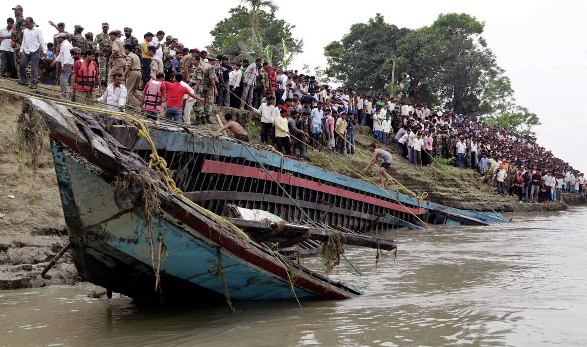 Rescuers pull out the wreckage of a ferry that capsized in the Brahmaputra River at Buraburi village, about 215 miles west of the state capital Gauhati, India, Tuesday, May 1, 2012. Army divers and rescue workers pulled more than 100 bodies out of a river after a packed ferry capsized in heavy winds and rain in remote northeast India, an official said Tuesday. At least 100 people were still missing Tuesday after the ferry carrying about 350 people broke into two pieces late Monday, said Pritam Saikia, the district magistrate of Goalpara district.