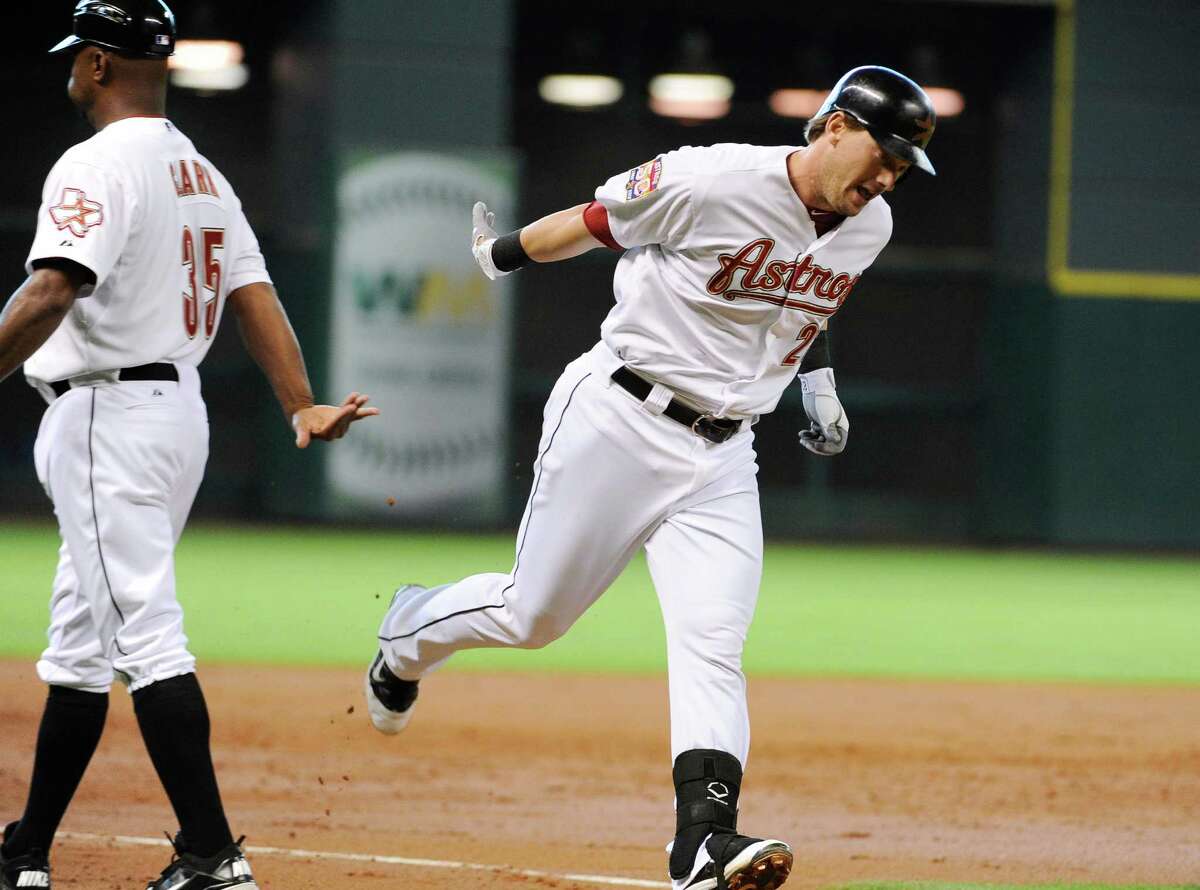 Houston Astros' Chris Johnson, right, rounds the bases past third base coach Dave Clark (35) after hitting a three-run home run against the New York Mets in the second inning of a baseball game, Wednesday, May 2, 2012, in Houston. (AP Photo/Pat Sullivan)