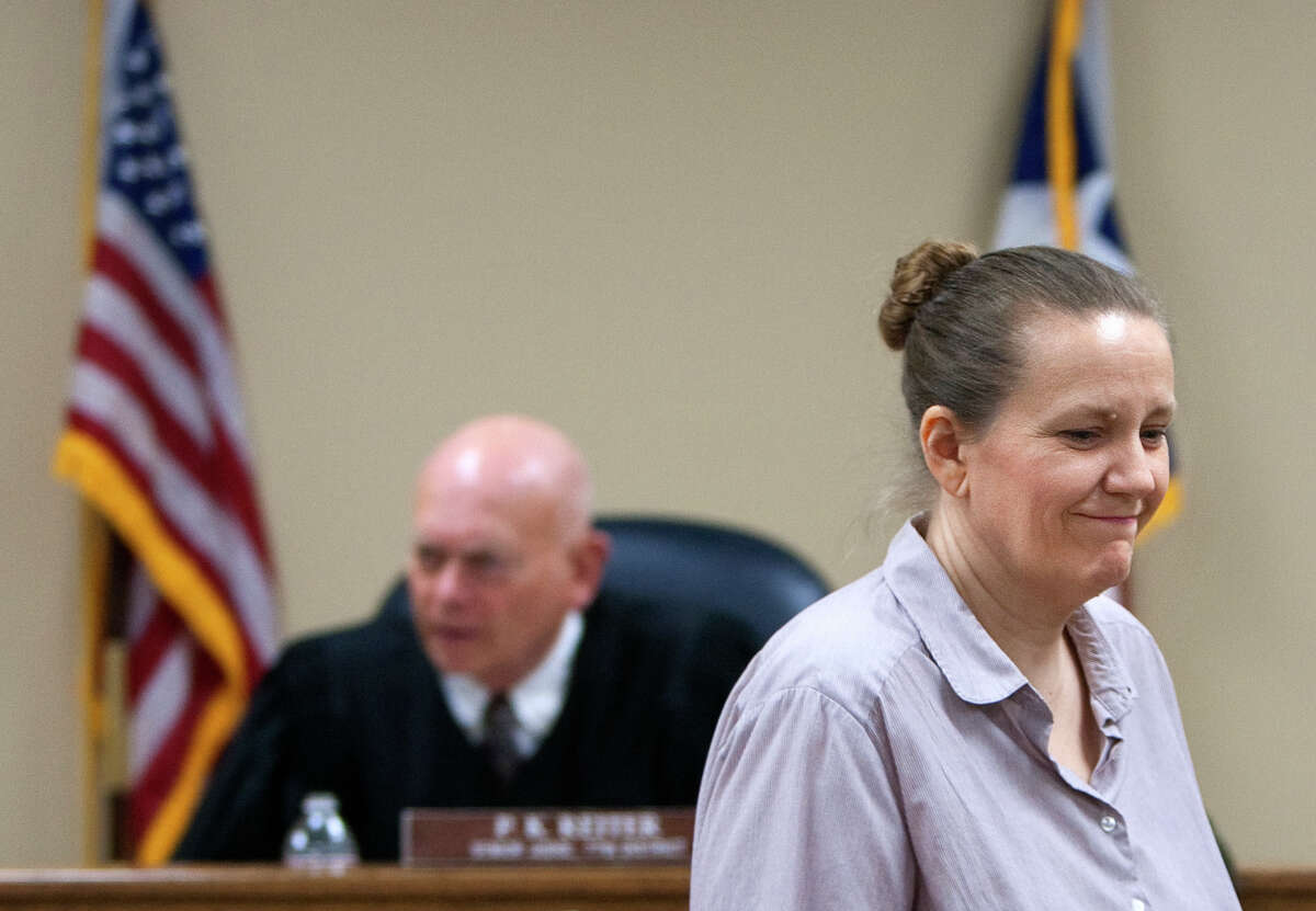 Sherrie Shorten, right, returns to her seat after testifying in front of 77th District Senior Judge P.K. Reiter, left, during a hearing to determine whether she would regain her children at the Montgomery County Courthouse Wednesday, May 2, 2012, in Conroe. The children were discovered living in a school bus that authorities described as filthy and reeking from sewage on March 7. Shorten and her husband at the time were in prison serving 18-month sentences for embezzlement and left a 60-year-old aunt in charge.