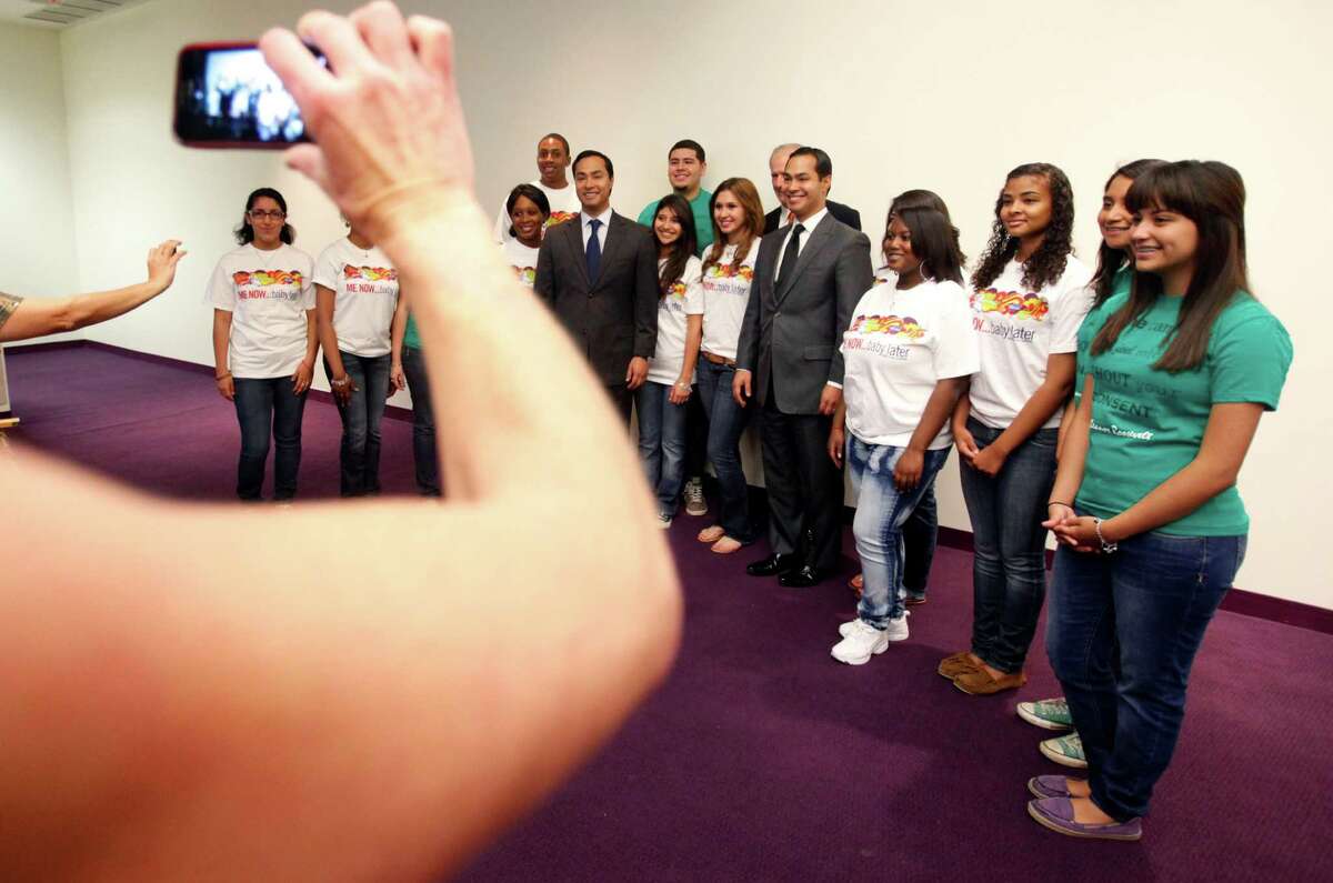 Teens involved in advocating against teenage pregnancy have their picture taken at a news conference announcing data on Texas and Bexar County teen birth rates during the National Day to Prevent Teen Pregnancy.