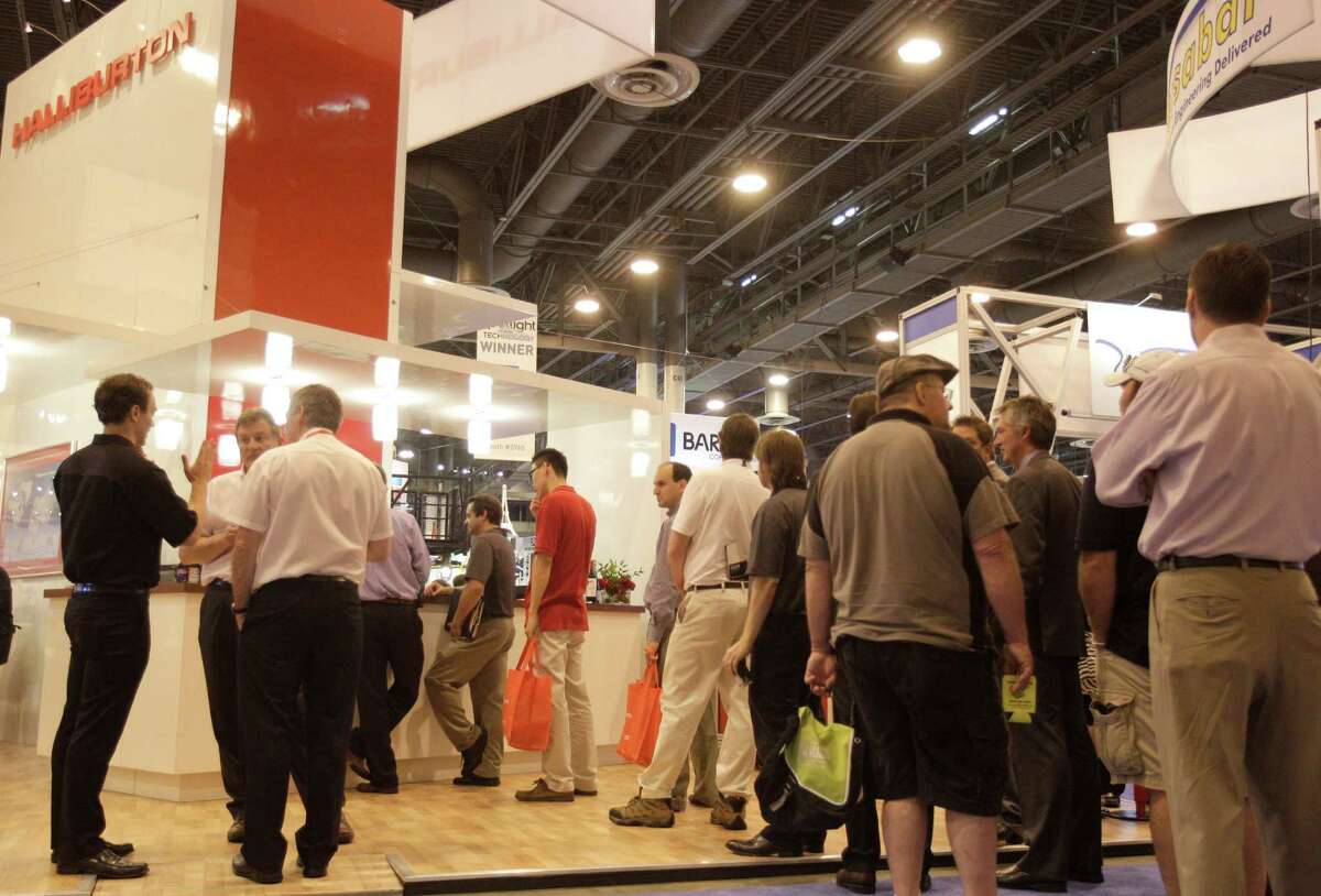 People wait in line at the Halliburton booth bar at OTC in Reliant Center Wednesday, May 2, 2012. (Melissa Phillip / Chronicle)