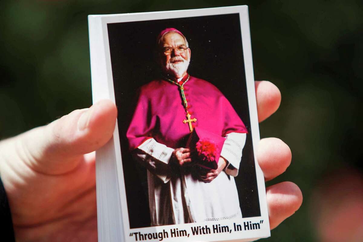 An usher holds photos of George Arthur Sheltz before the service for Houston native George Arthur Sheltz to be ordained a Catholic bishop at the Co-Cathedral of the Sacred Heart, Wednesday, May 2, 2012, in Houston.