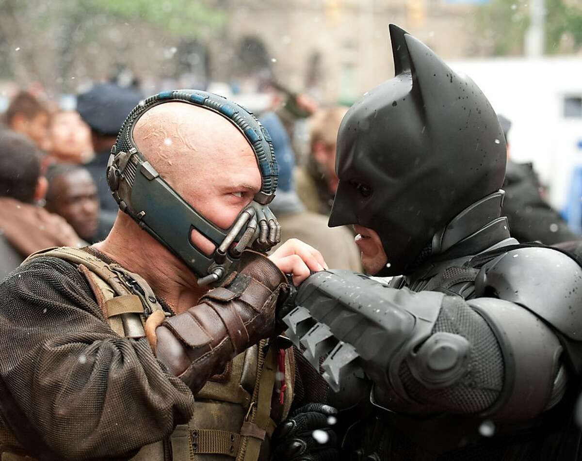 Christian Bale, right, in THE DARK KNIGHT RISES (L-r) TOM HARDY as Bane and CHRISTIAN BALE as Batman in Warner Bros. Pictures' and Legendary Pictures' action thriller “THE DARK KNIGHT RISES,” a Warner Bros. Pictures release. TM and © DC Comics