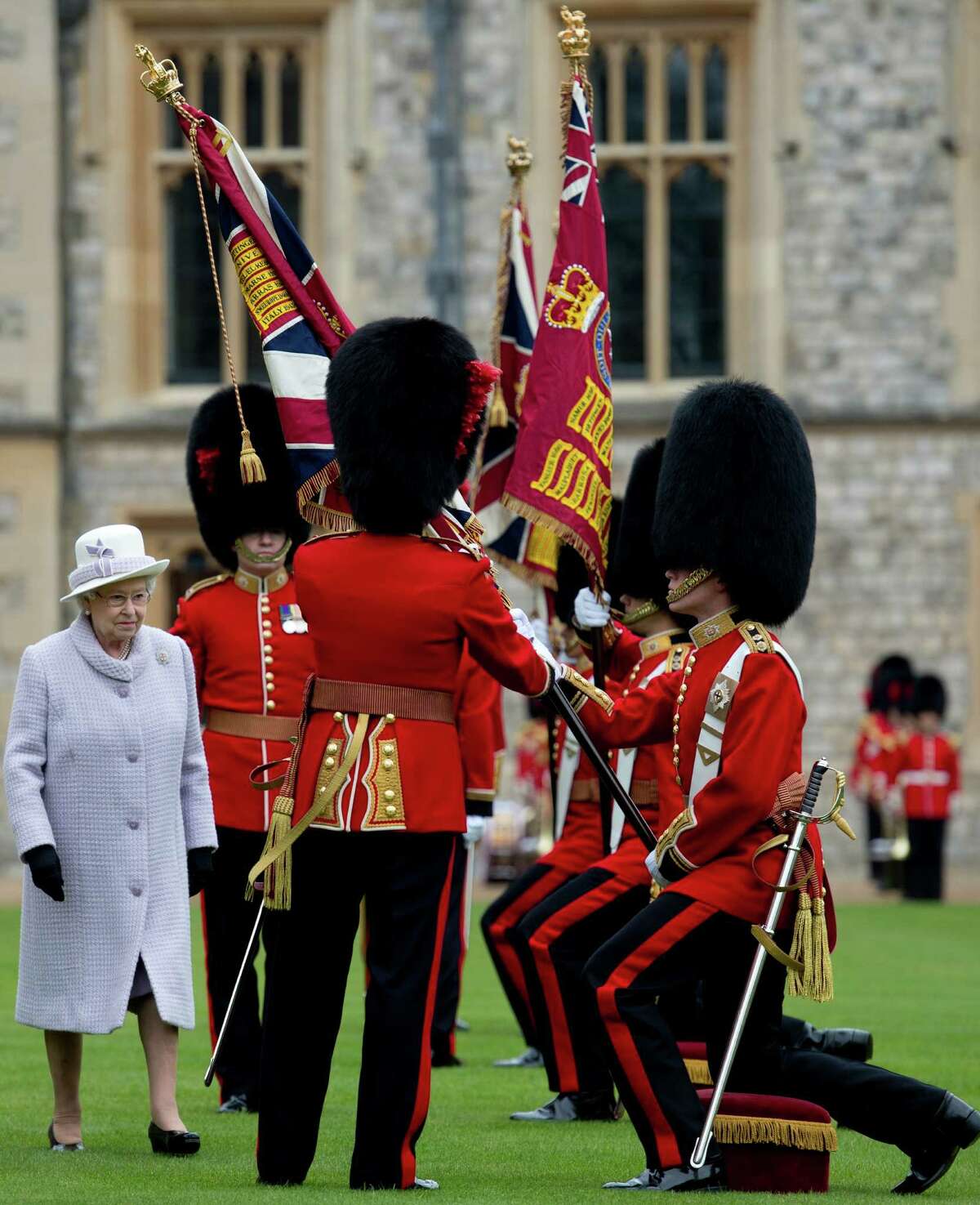 Britain's Queen Elizabeth II (L) presents New Colours to the 1st Battalion and No. 7 Company the Coldstream Guards at Windsor Castle, Berkshire, west of London, on May 3, 2012. The Queen presented New Colours to the 1st Battalion and No. 7 Company of the Coldstream Guards and then inspected the Parade. The Coldstream Guards, the oldest regiment in the British Army, will form part of the guard for Trooping the Colour in honour the the Queen's birthday in June following which the regiment will prepare for deployment to Afghanistan once more. AFP PHOTO / POOL / BEN STANSALLBEN STANSALL/AFP/GettyImages