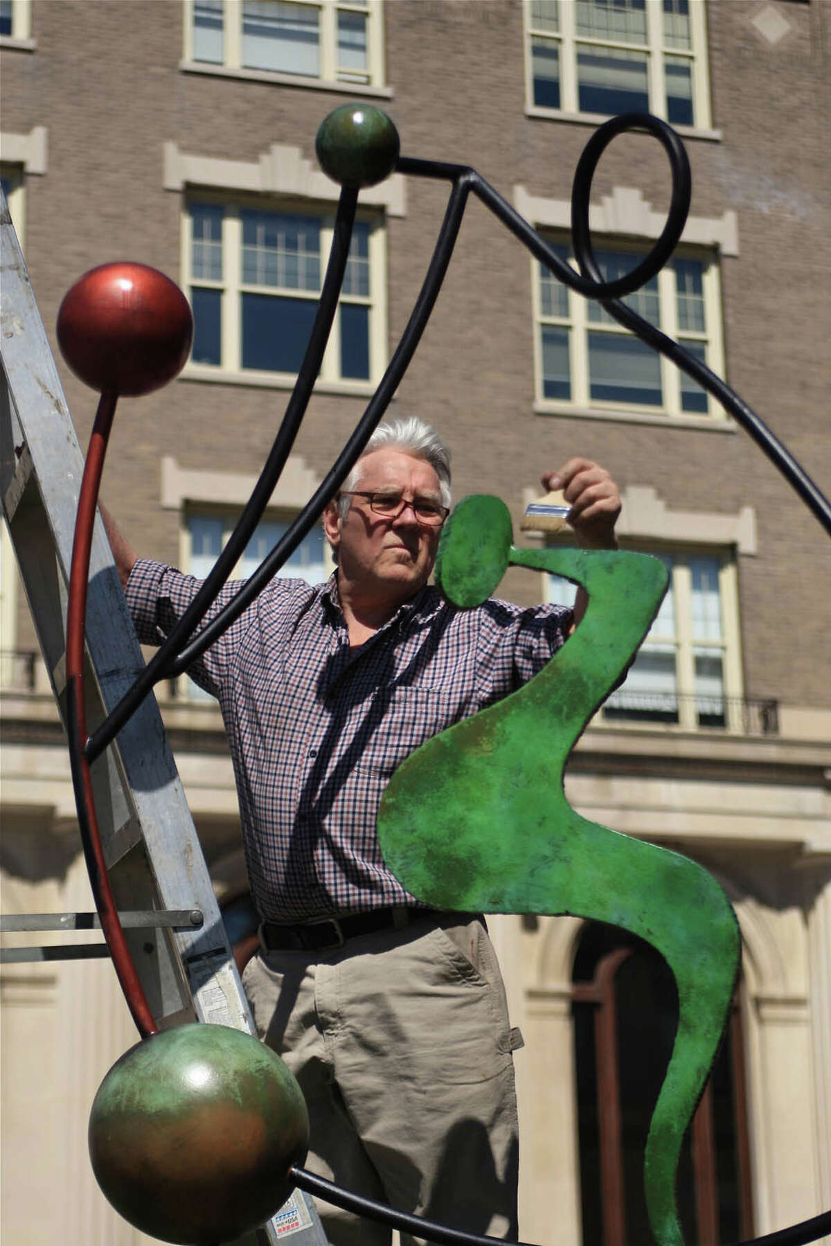 Sculptor Charlie Hewitt installs a sculpture on Greenwich Avenue in Greenwich last month. It is one of several new steel sculptures installed by the nationally known artist in conjunction with the Greenwich Arts Council's annual Art to the Avenue celebration that runs for most of the month of May. Beginning May 3, 2012, the program will transform Greenwich Avenue, and some nearby streets, into one large art gallery. Visitors to the area will be encouraged to wander into retail spots and check out art from 150 artists. The program, which kicks off with an opening night from 5:30 to 8 p.m., runs through May 28. Contributed photo/J.D. Durrans.