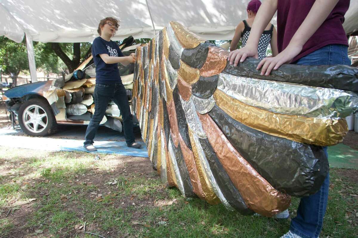 Senior Claire Schaffer and freshman Boying Meng work on the wing of the Owl Car at Rice University. The car will be entered into the Houston Art Car Parade.