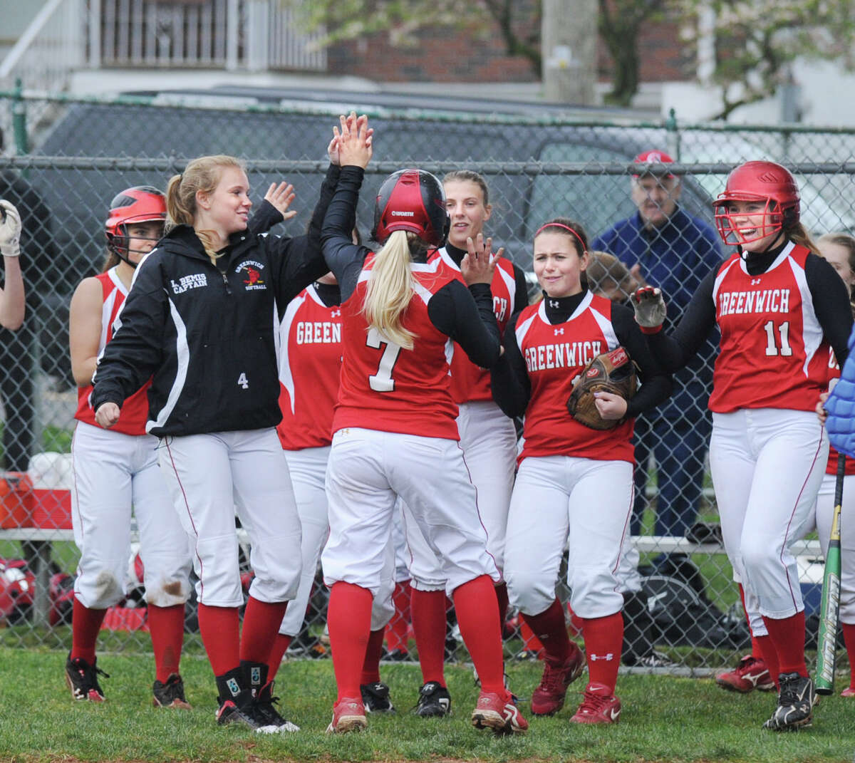 Rebecca DeCarlo # 7 of Greenwich High School is congratulated by teammates after hitting a three-run home run during the top of the second inning of softball game between Greenwich High School and Port Chester High School at Port Chester, N.Y., Thursday, May 3, 2012. Greenwich defeated Port Chester 23-0. At right for Greenwich is Ebba Mark # 11.