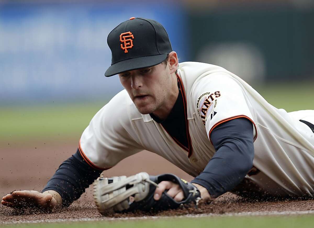 San Francisco Giants third baseman Conor Gillaspie makes a diving stop on a ground ball by Miami Marlins' Emilio Bonifacio during the first inning of a baseball game in San Francisco, Thursday, May 3, 2012. Bonifacio was safe on Gillaspie's ensuing throw to first base. (AP Photo/Marcio Jose Sanchez)