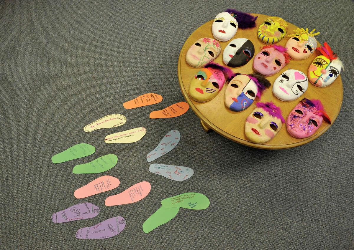 Masks and footprints made by women in the domestic violence support group are shown at the Women's Center of Greater Danbury on Thursday, May 3, 2012. The masks represent what the victim is showing the world, while also showing what is going on on the inside. The footprints represent what it means to walk in the victim's shoes. Scaros-Mercado is a drama therapist and licensed creative arts therapist.