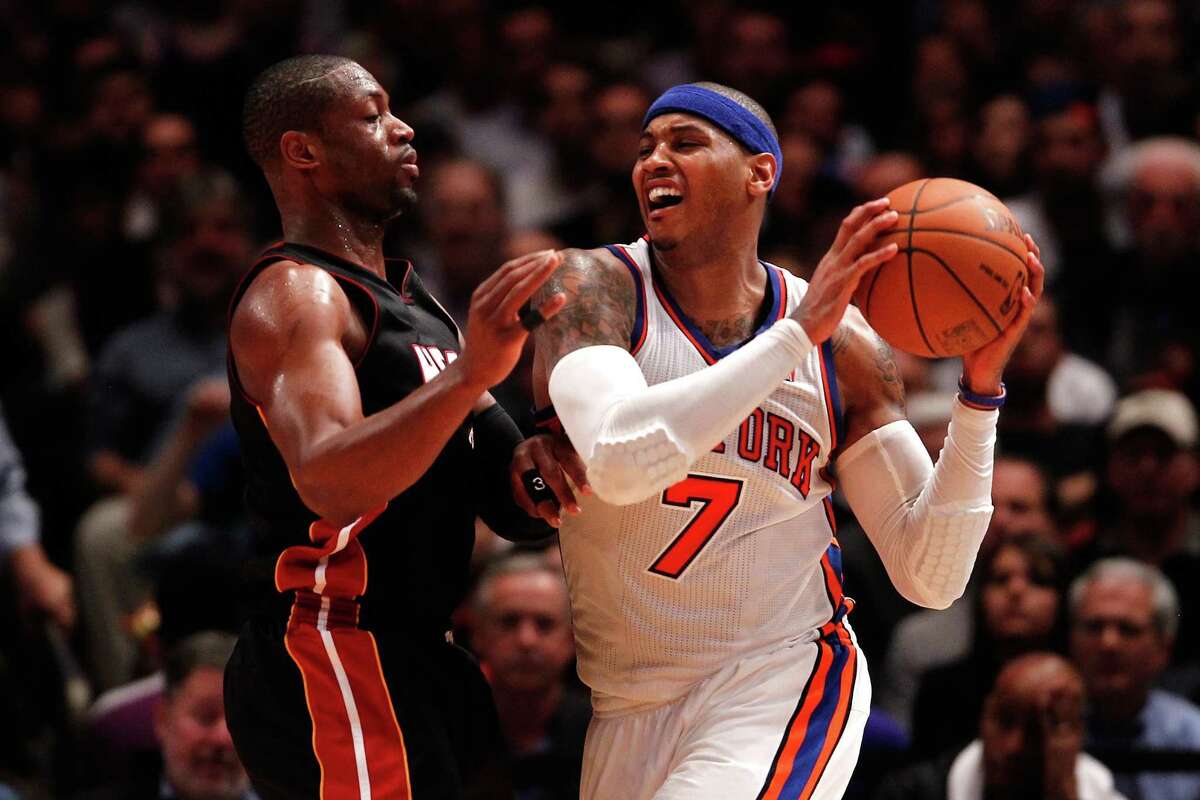 Carmelo Anthony of the Knicks looks to pass while being defended by Miami's Dwyane Wade during Thursday's playoff game.