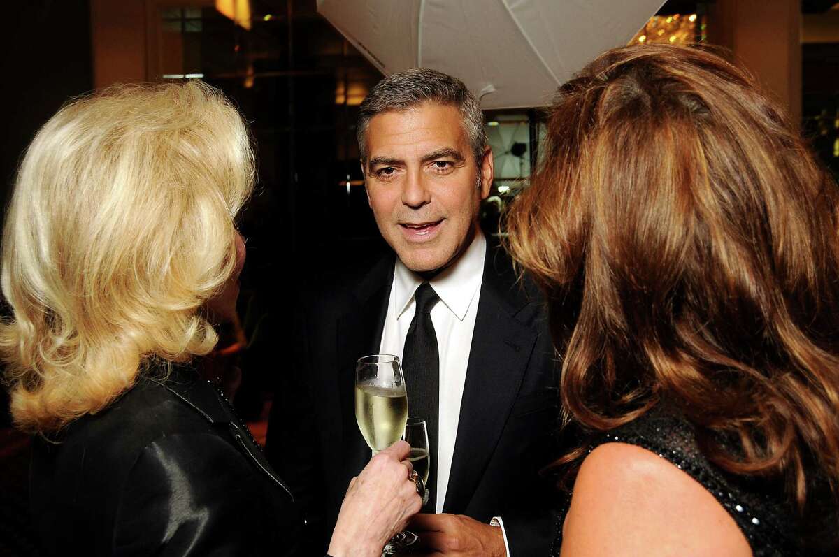George Clooney chats with Lynn Wyatt and Cherie Flores before his appearance at the Brilliant Lecture Series at the Wortham Theater Thursday May 3,2012. (Dave Rossman Photo)