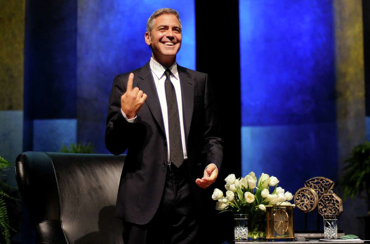 George Clooney smiles at the crowd after he was introduced at the Brilliant Lecture Series at the Wortham Theater Thursday May 3,2012. (Dave Rossman Photo)