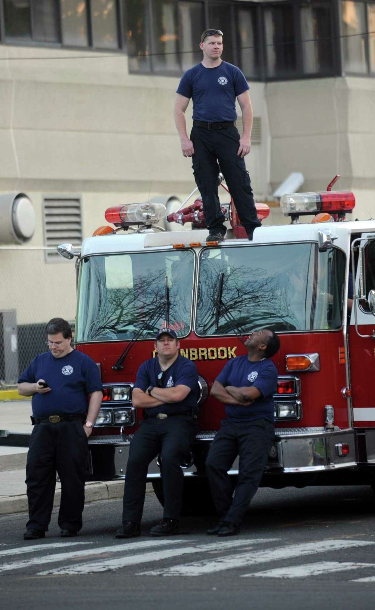 Members of the Glenbrook Fire Department watch the proceedings from their truck during the 6th annual Stamford Police Department Memorial Parade on Friday, May 4, 2012.