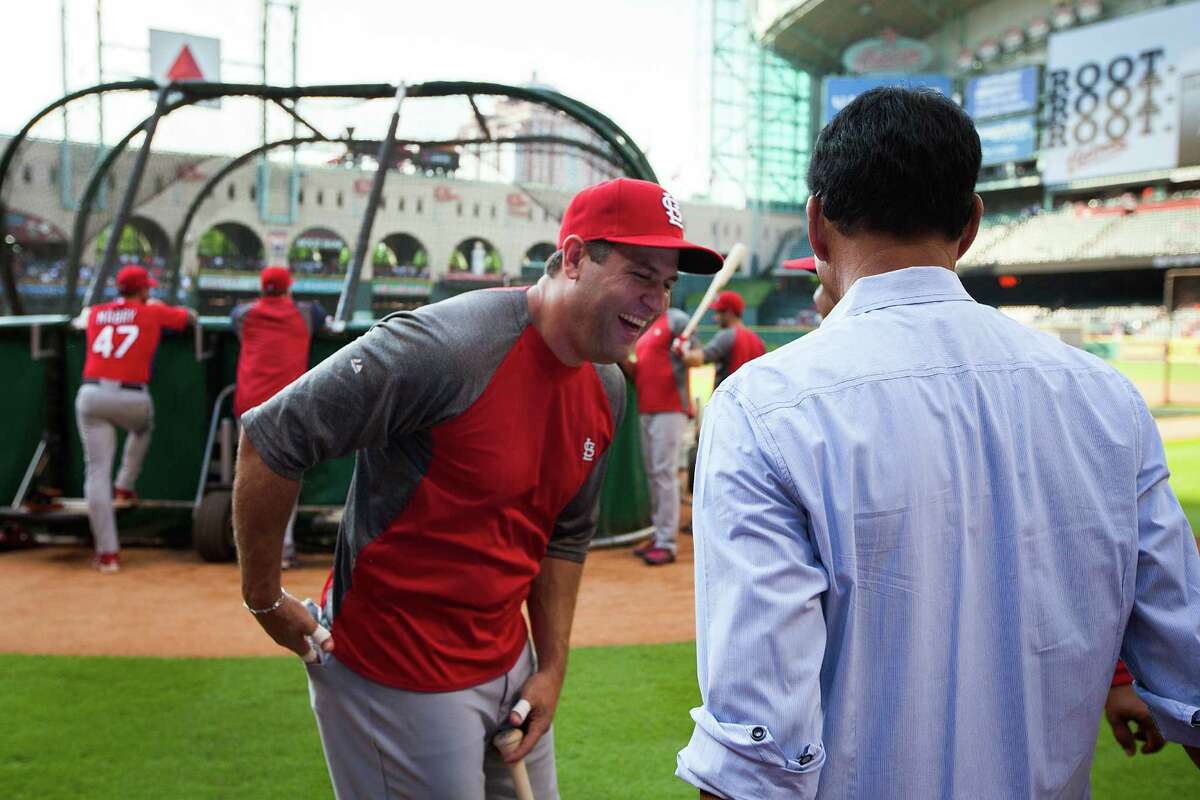 St. Louis Cardinals first baseman Lance Berkman laughs with former Houston Astros player and coach Jose Cruz during batting practice before facing the Houston Astros at Minute Maid Park on Friday, May 4, 2012, in Houston. Berkman, the former Astros player, is on the disabled list for the Cardinals.