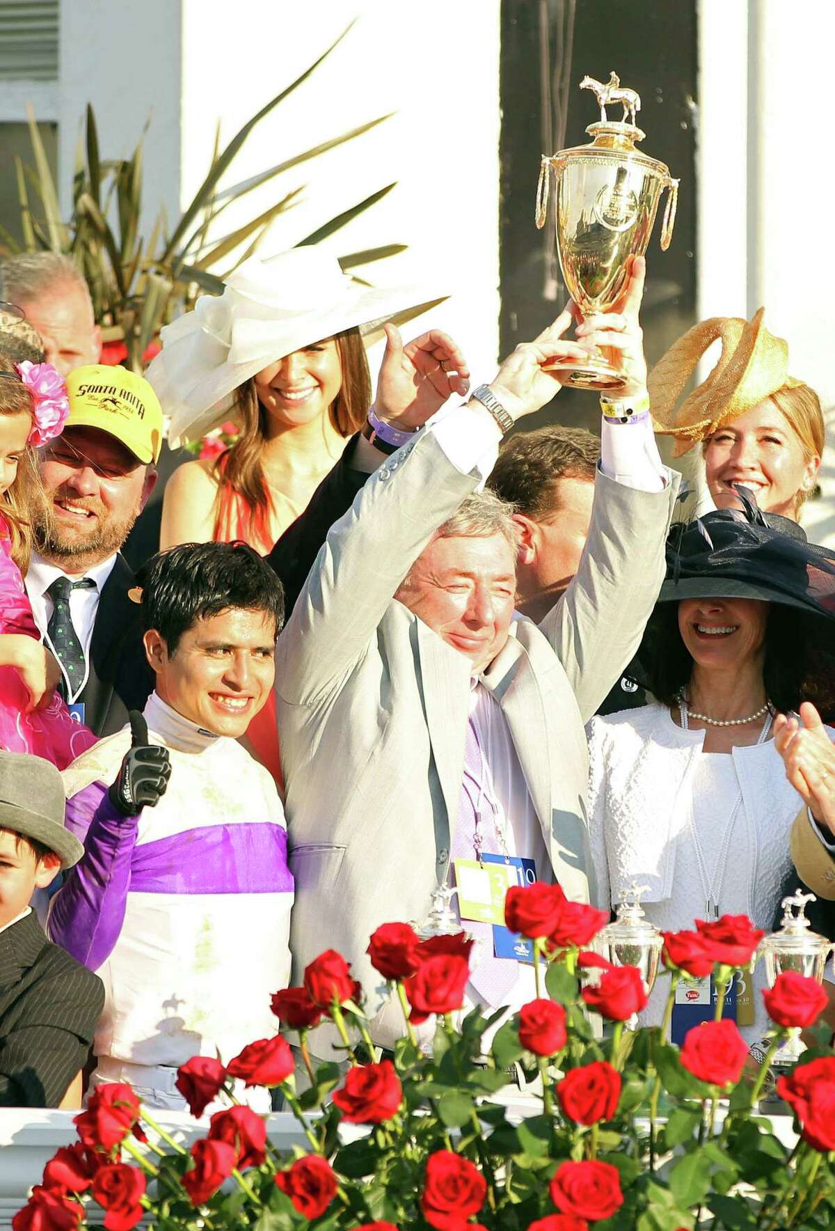 LOUISVILLE, KY - MAY 05: Owner J. Paul Reddam holds up the trophy as Mario Gutierrez and trainer Doug O'Neill (L) after their horse I'll Have Another won the 138th running of the Kentucky Derby at Churchill Downs on May 5, 2012 in Louisville, Kentucky.