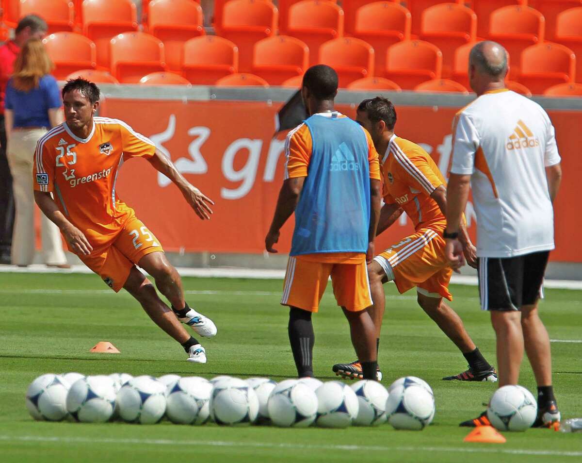The Houston Dynamo's Brian Ching left, during the Houston Dynamo soccer team practice at BBVA Compass Stadium Saturday, May 5, 2012, in Houston.