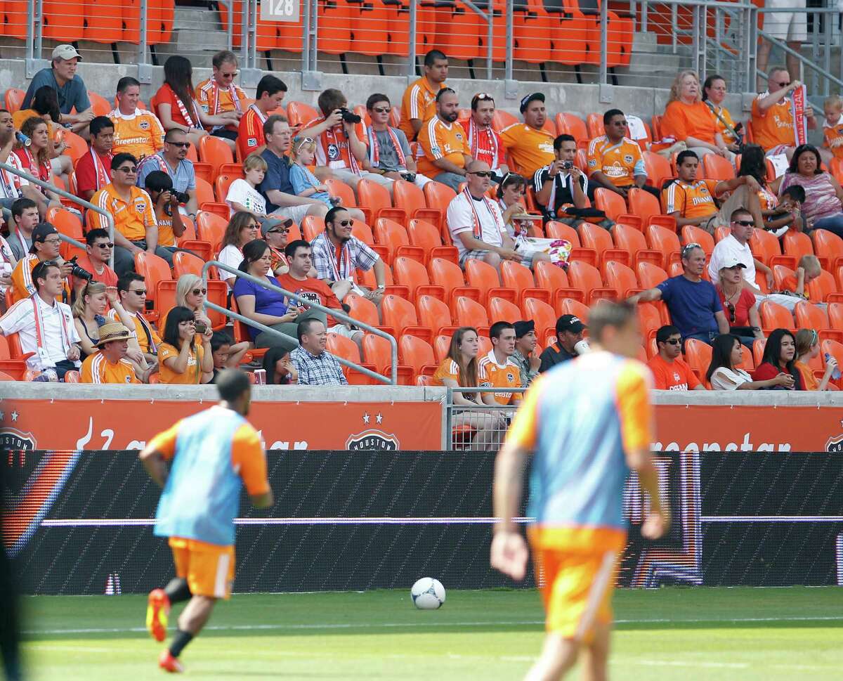 Fans watch as the Houston Dynamo soccer team practices at BBVA Compass Stadium Saturday, May 5, 2012, in Houston.