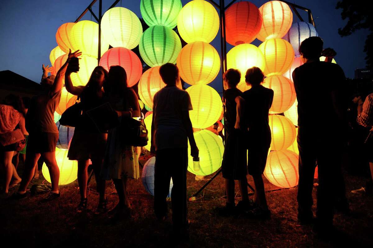 People explore a lantern display during Luminaria 2012 in Hemisfair Park on Saturday, May 5, 2012.