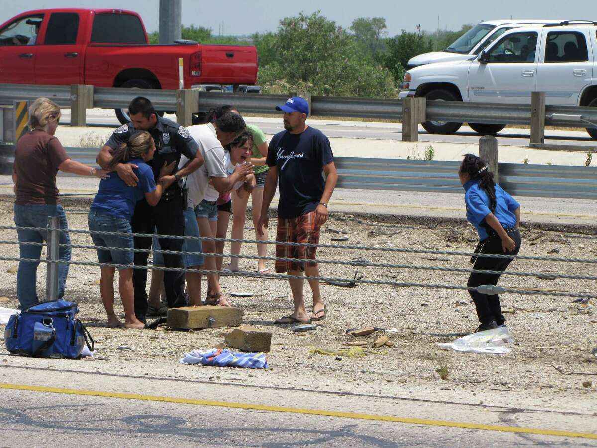 Friends and relatives react at the scene of a rollover crash that killed two children on the Southwest Side Sunday afternoon, May 6, 2012.