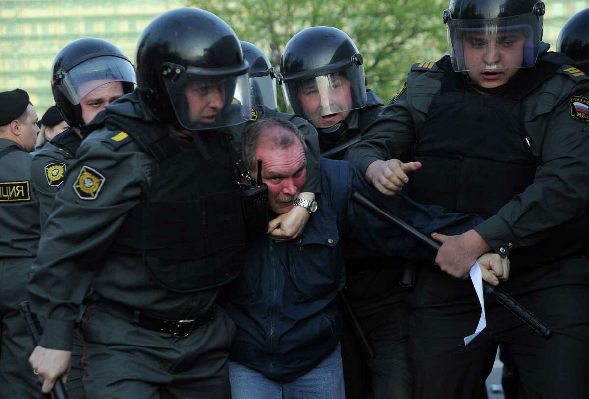 Russian Police officers detain opposition supporters during a rally in Moscow on May 6, 2012. Russian riot police violently clashed with protesters at a rally on the eve of strongman Vladimir Putin's return for a third Kremlin term, arresting over 250 people including opposition leaders.