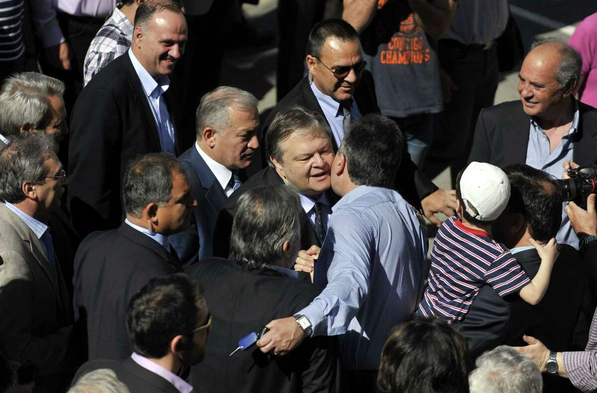 Leader of the Greek Socialist PASOK party Evangelos Venizelos, center, is greeted by supporters upon his arrival outside a polling station in Thessaloniki, northern Greece Sunday May 6, 2012. Greeks cast ballots on Sunday in their most critical _ and uncertain _ election in decades, with voters set to punish the two main parties that are being held responsible for the country's dire economic straits. (AP Photo/Nikolas Giakoumidis)