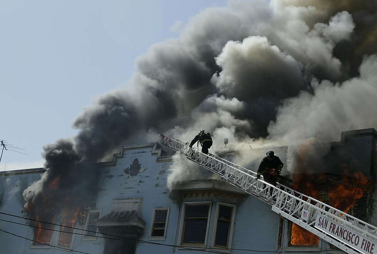 San Francisco firefighters battle a four-alarm fire at a residential and commercial building on the corner of Valencia Street and Duboce Avenue in San Francisco, Sunday, May 6, 2012. (AP Photo/Jeff Chiu)