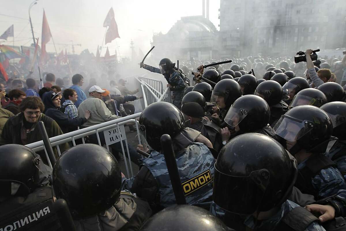 Russian riot police disperse opposition protesters in downtown Moscow on Sunday, May 6, 2012. Riot police in Moscow have begun arresting protesters who were trying to reach the Kremlin in a demonstration on the eve of Vladimir Putin's inauguration as president. (AP Photo/Sergey Ponomarev)