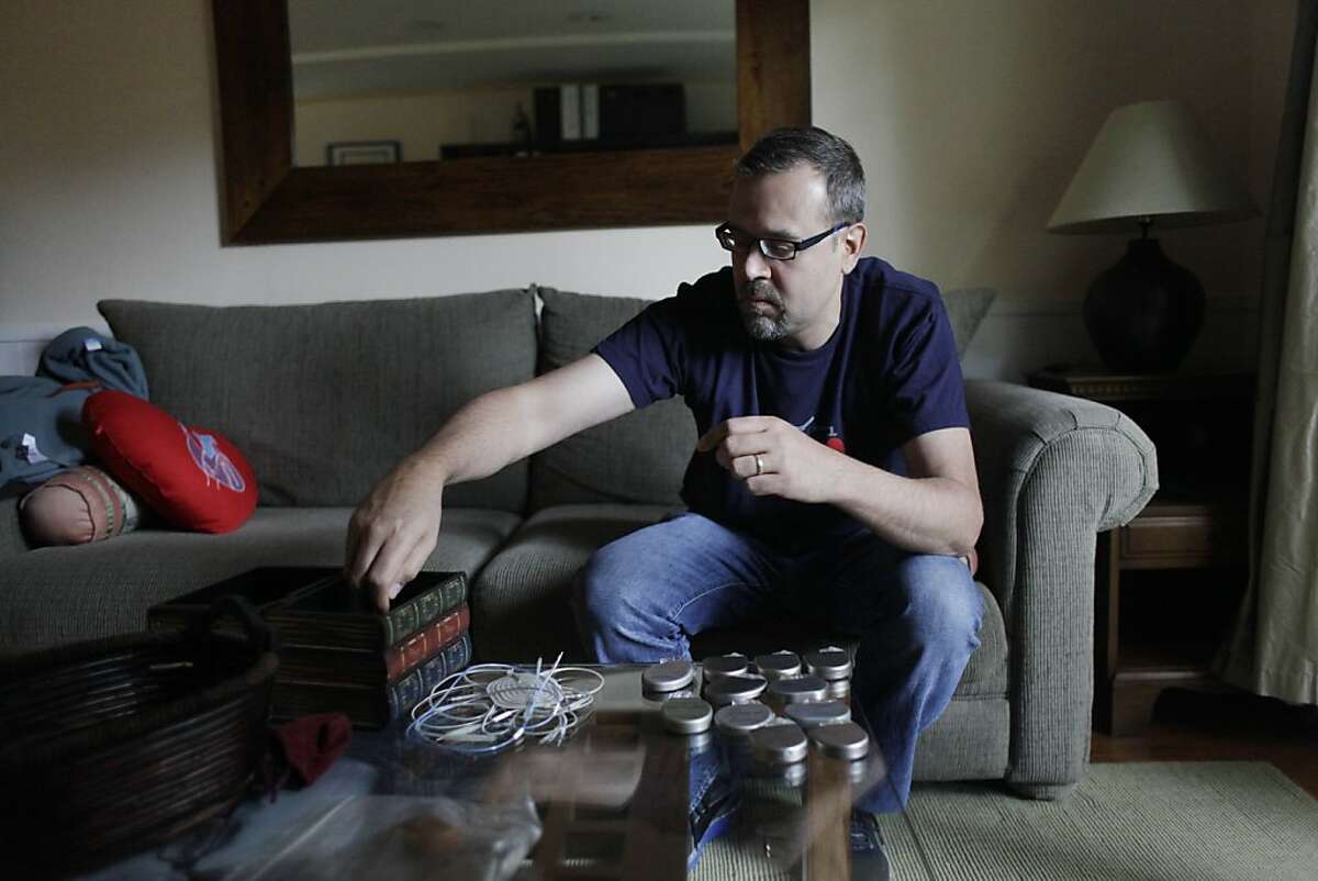 Hugo Campos of Oakland displays his collection of defibrillators which he started after being told he would have to have one on Thursday, May 3, 2012 in Oakland, Calif.