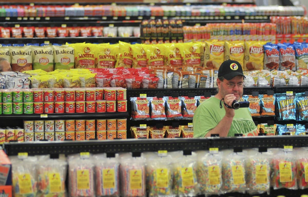 A customer uses a video camera to record the new Buc-ee's store in New Braunfels on opening day, Monday, May 7, 2012.
