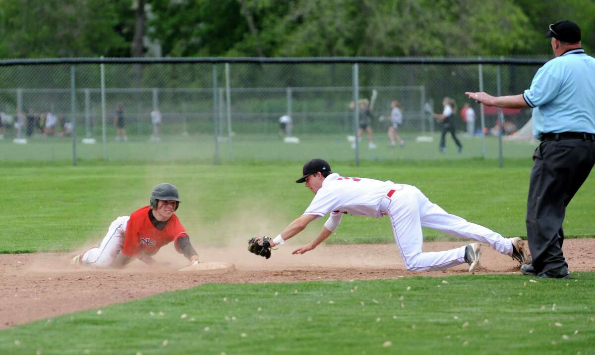 New Canaan High School's #21, Grady Amrhein, slides into 2nd base, against Greenwich High School's #7, shortstop Dylan Callahan at baseball, hosted by Greenwich Monday, May 7, 2012. Greenwich High School won 4 to 3 against New Canaan High School.