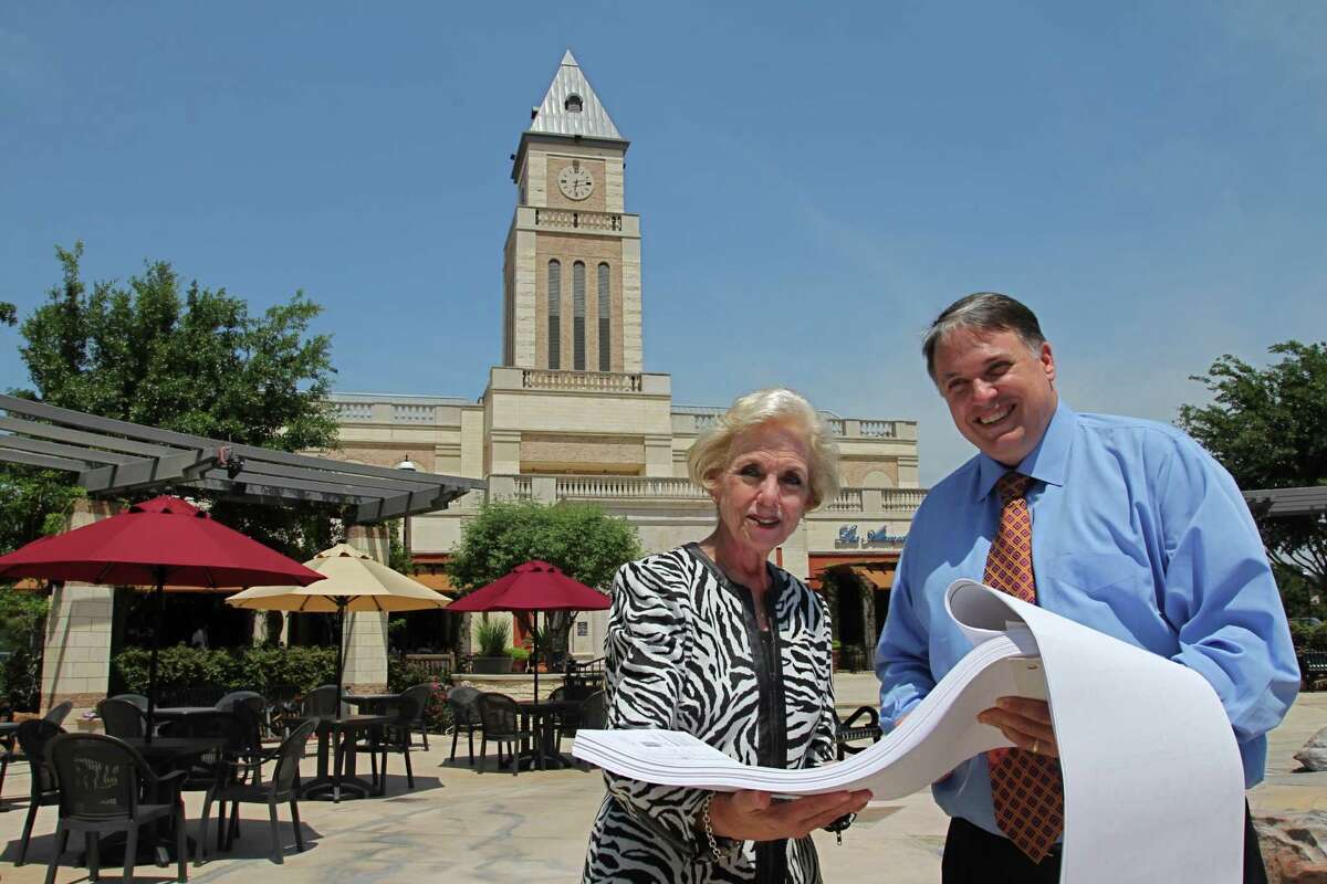 Ann Hodge, president/CEO of the Katy Area Chamber of Commerce, and Lance LaCour, president/CEO of the Katy Area Economic Development Council, look at plans for the expansion of LaCenterra at Cinco Ranch. The upscale shopping mecca is known for its clock tower.