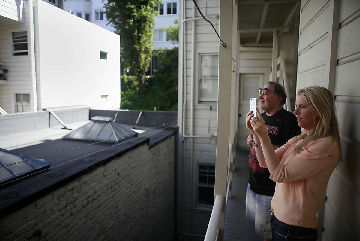 Len, the apartment manager takes Wendy Willbanks on to the porch to see the view outside of the apartment. Wendy Willbanks started a service called She Moves You, where Wendy scouts apartments on behalf of her clients. With he camera phone in hand, Wendy visits open houses and looks for the best apartments in the city.