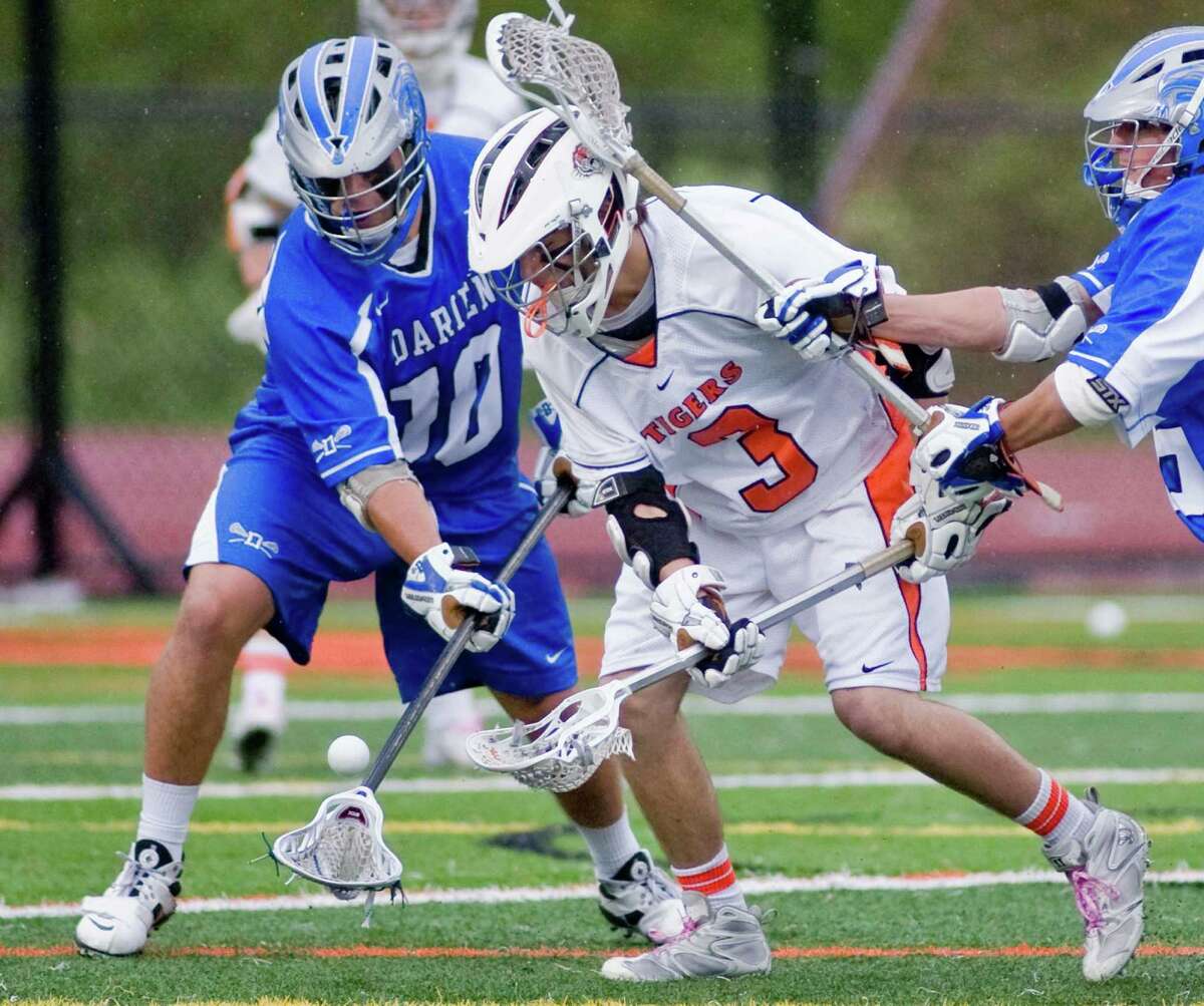 Darien High School's Tony Britton and Ridgefield High School's Sean Riley fight for the loose ball during a lacrosse game at Ridgefield. Tuesday, May 8, 2012