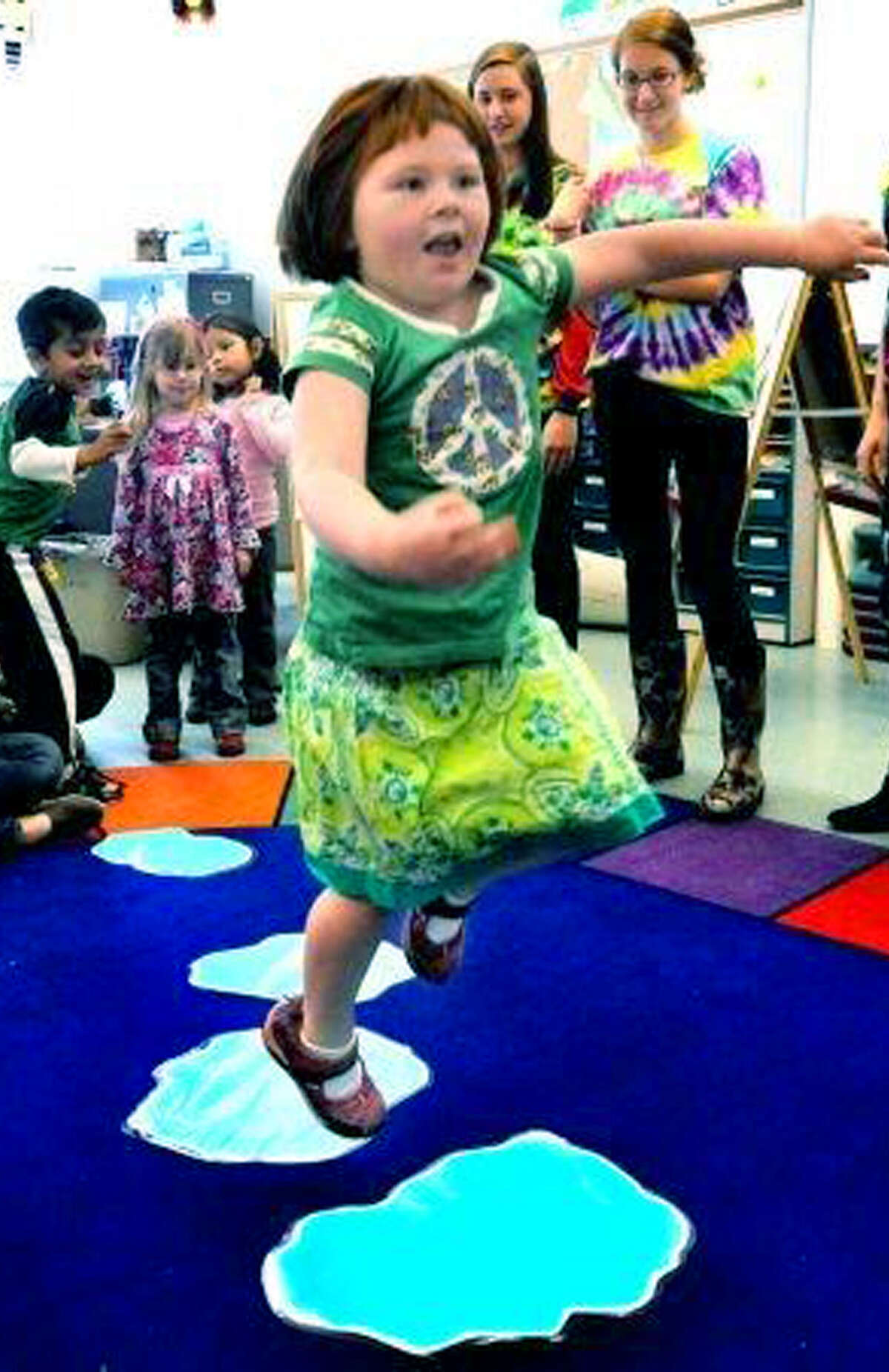 Emma Kavaneah, 5, jumps "puddles" during a child development class at New Milford High School. April 12, 2012