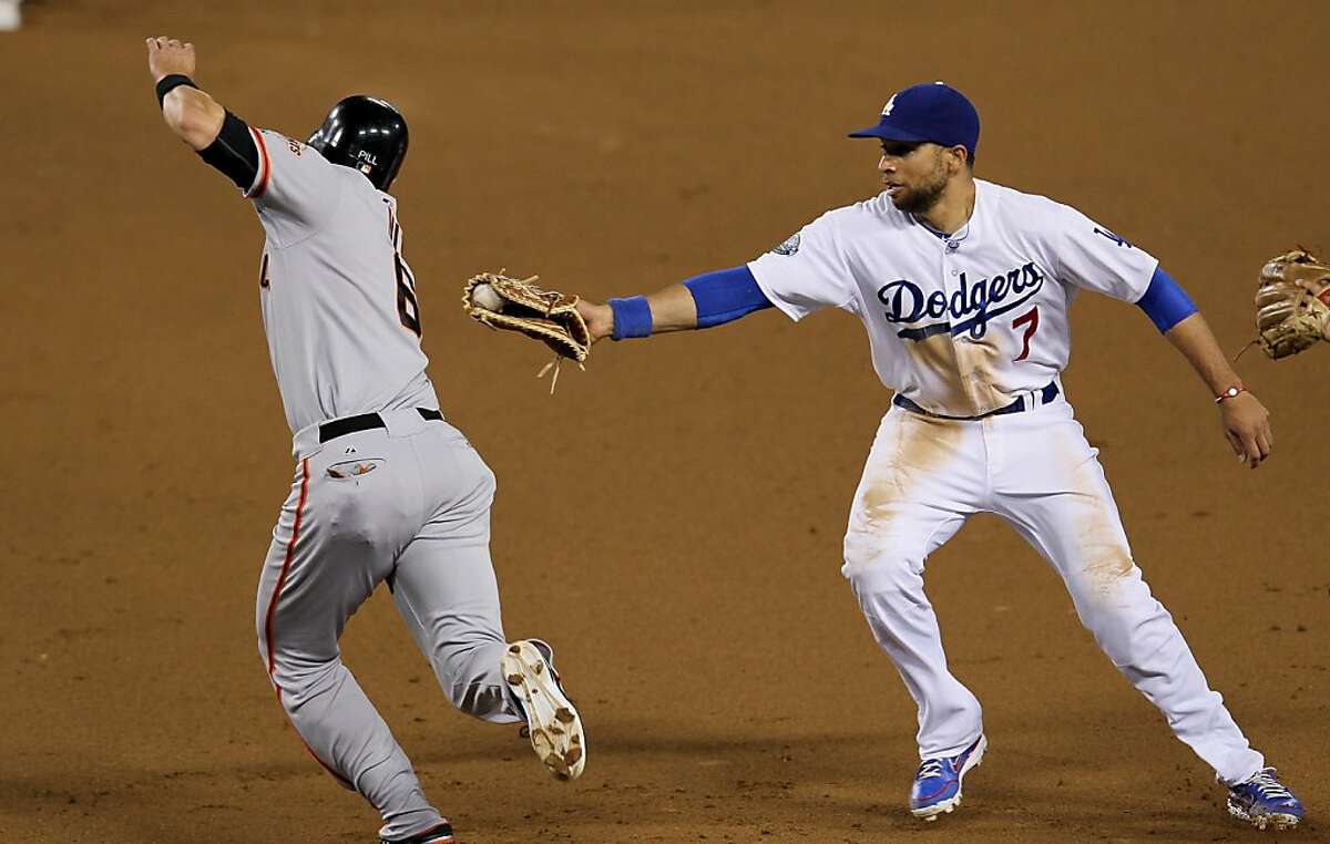 LOS ANGELES, CA - MAY 08: First baseman James Loney #7 of the Los Angeles Dodgers tags out Brett Pill #6 of the San Francisco Giants before stepping on first for a force out and an unassisted double play on May 8, 2012 at Dodger Stadium in Los Angeles, California. . (Photo by Stephen Dunn/Getty Images)