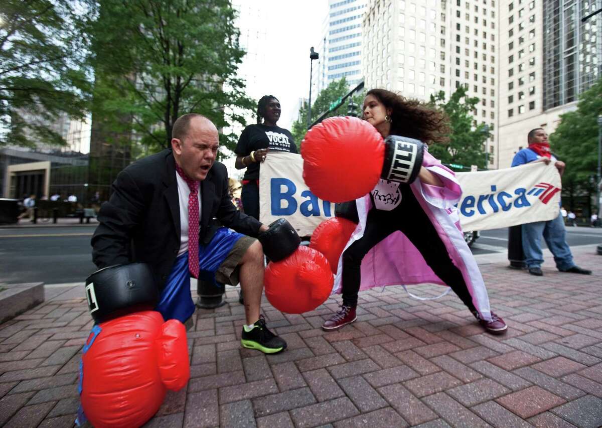 Activists with the 99 Percent Spring movement perform a boxing routine outside of the annual Bank of America Corp. shareholders meeting on May 9, in Charlotte, N.C. The 99 Percent Spring movement drew inspiration from the Occupy Wall Street movement and covers a range of issues and actions.