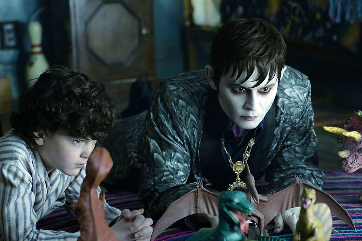 In this film image released by Warner Bros., Gully McGrath portrays David Collins, left, and Johnny Depp portrays Barnabas Collins in a scene from "Dark Shadows." (AP Photo/Warner Bros., Peter Mountain)