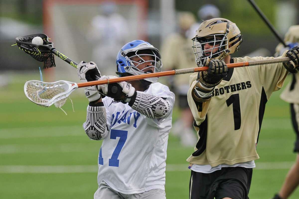 Albany Lacrosse Modified Team player Dejeir Coleman, left, during their game against CBA on Monday May 7, 2012 in Albany, NY. CBA's Kyran Nigro is at right. (Philip Kamrass / Times Union )