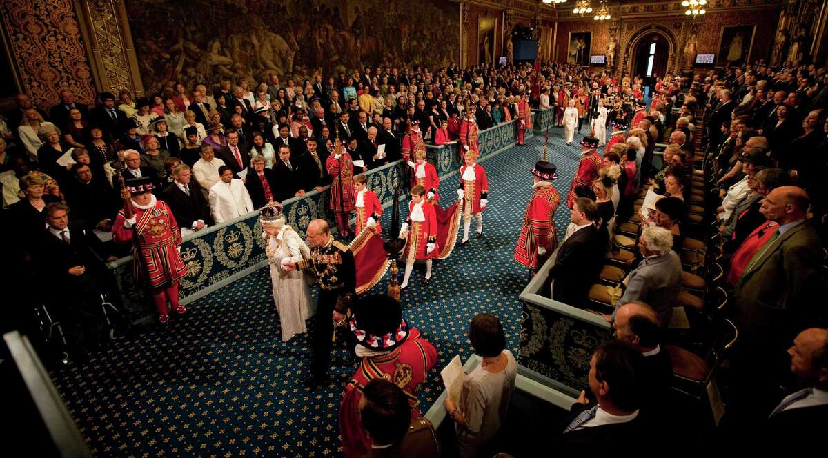 Britain's Queen Elizabeth II and Prince Philip, Duke of Edinburgh, proceed through the Royal Gallery toward the Chamber of the House of Lords in the Palace of Westminster during the State Opening of Parliament in London on May 9, 2012.